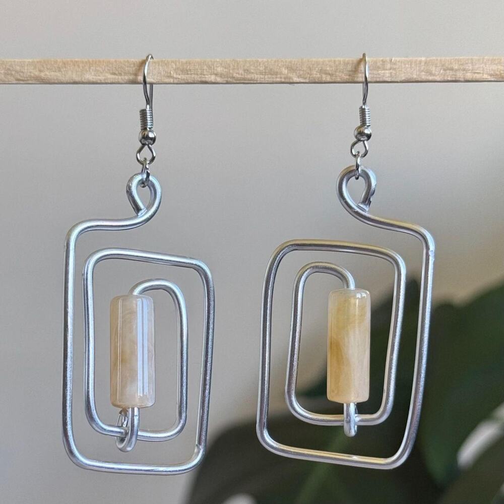 handmade silver wire spiral earrings with cream colored tube beads